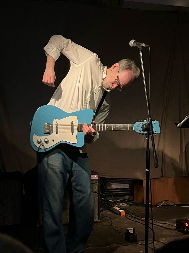 Musician Arto Lindsay playing guitar on stage at Café OTO, London, 14 October 2023.