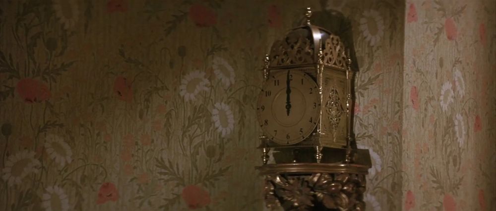 A screenshot from the film Labyrinth showing a brass lantern style clock