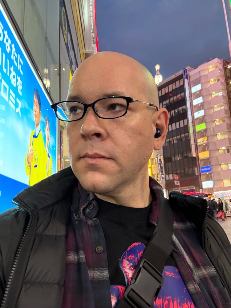 Me, but with a shaved head, looking to stage left.