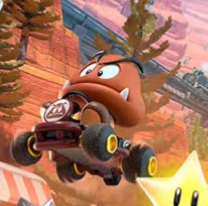 Goomba from mario kart driving but he no have no hands so how? I say goombenis.
