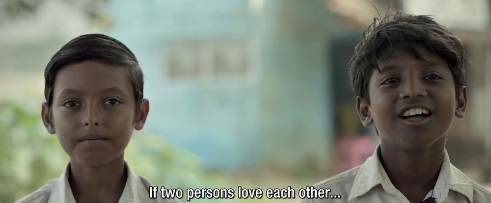 Same boys now facing the camera and smiling. Caption: “If two persons love each other…”