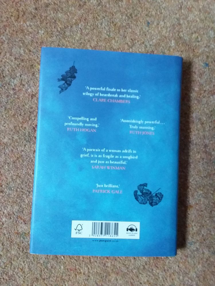 The back cover is also fofferent shades of blue with two drawings of autumnal leaves, one oak and another I am not sure of, floating down. It also includes several quotes form authors praising the book.