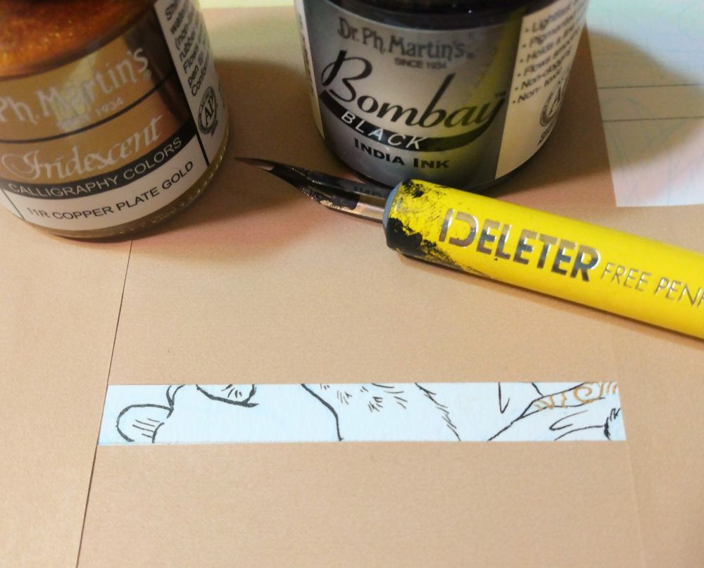 Tiny rectangle of a portion of an inked drawing, surrounded by beige paper blocking the rest of the picture. A yellow nib pen lays next to it with two bottles of ink, one black, one gold.