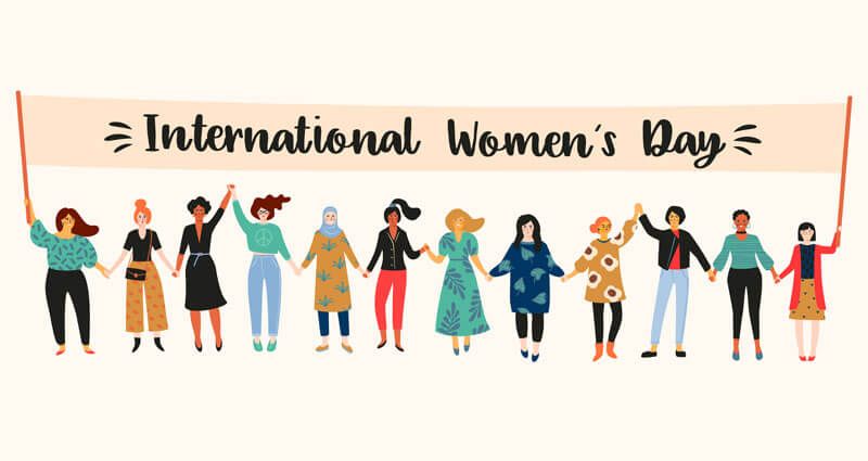 A drawing of 12 women of different backgrounds and shapes holding a banner that says "International Women's Day."