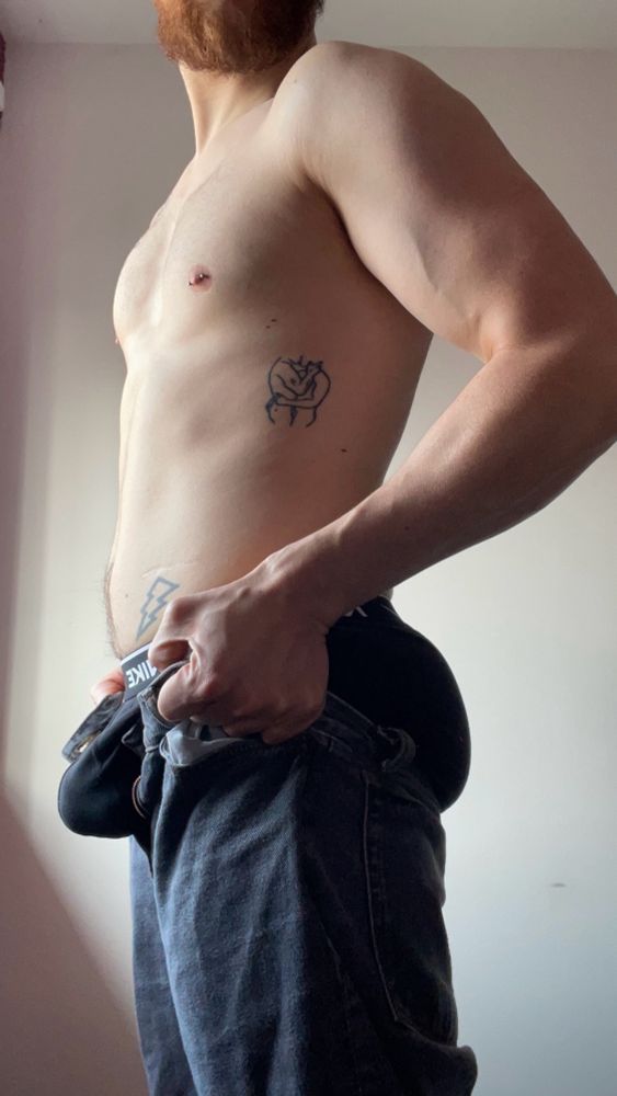 Stood at a side profile, pulling my jeans up in a way that cups both my crotch and ass simultaneously, accentuating both.