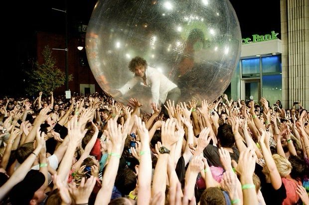 Wayne Coyne of Flaming Lips surfing the crowd inside an inflatable balloon