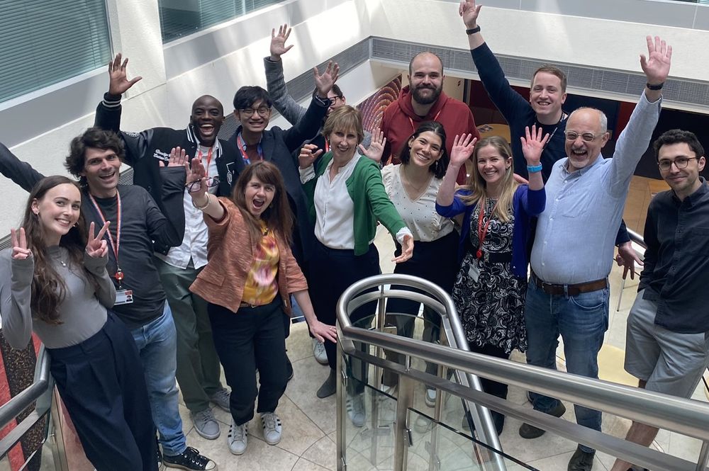 Picture of Cathryn Lewis' research group at the SGDP Centre, waving and smiling. 
