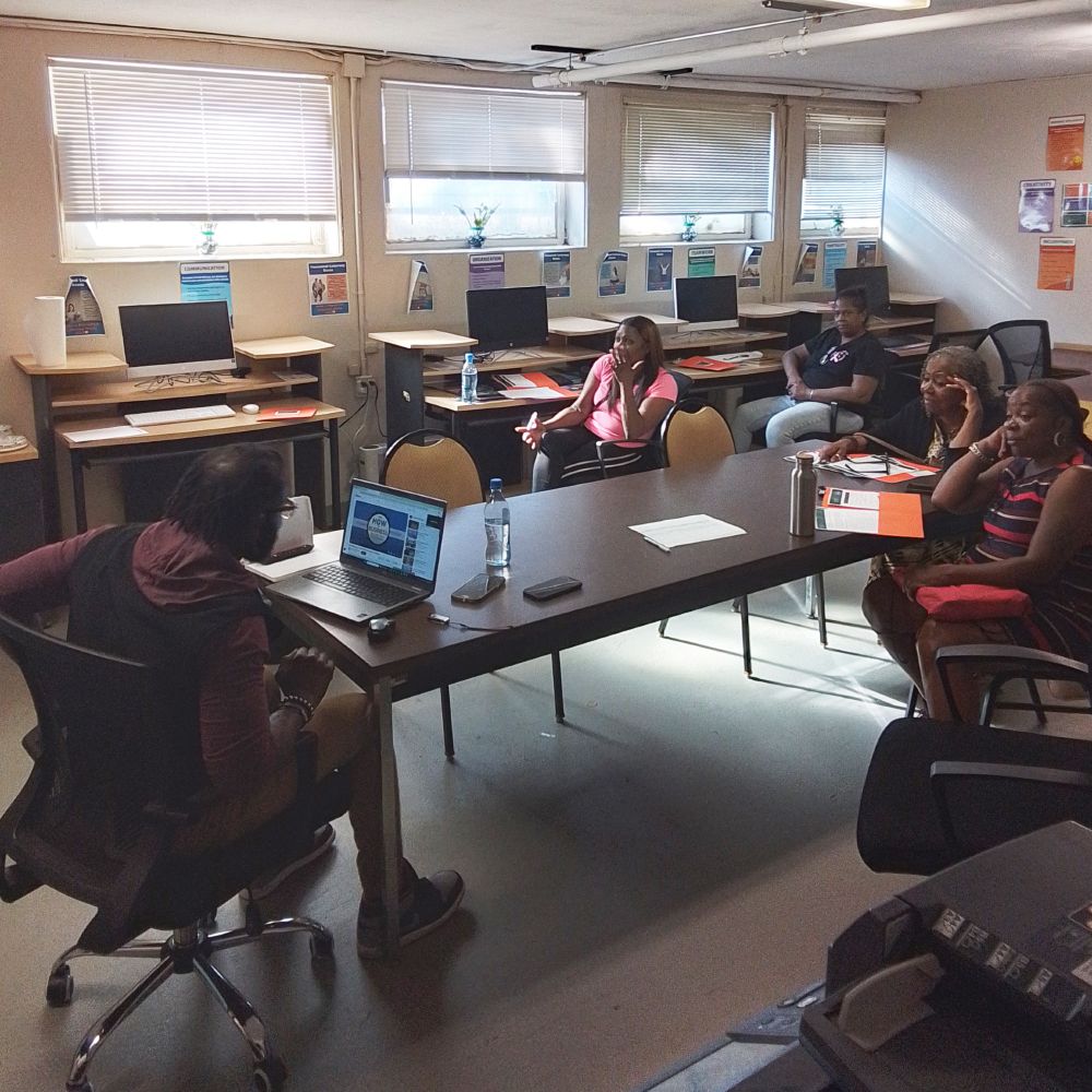 A group of people sitting around a table in discussion