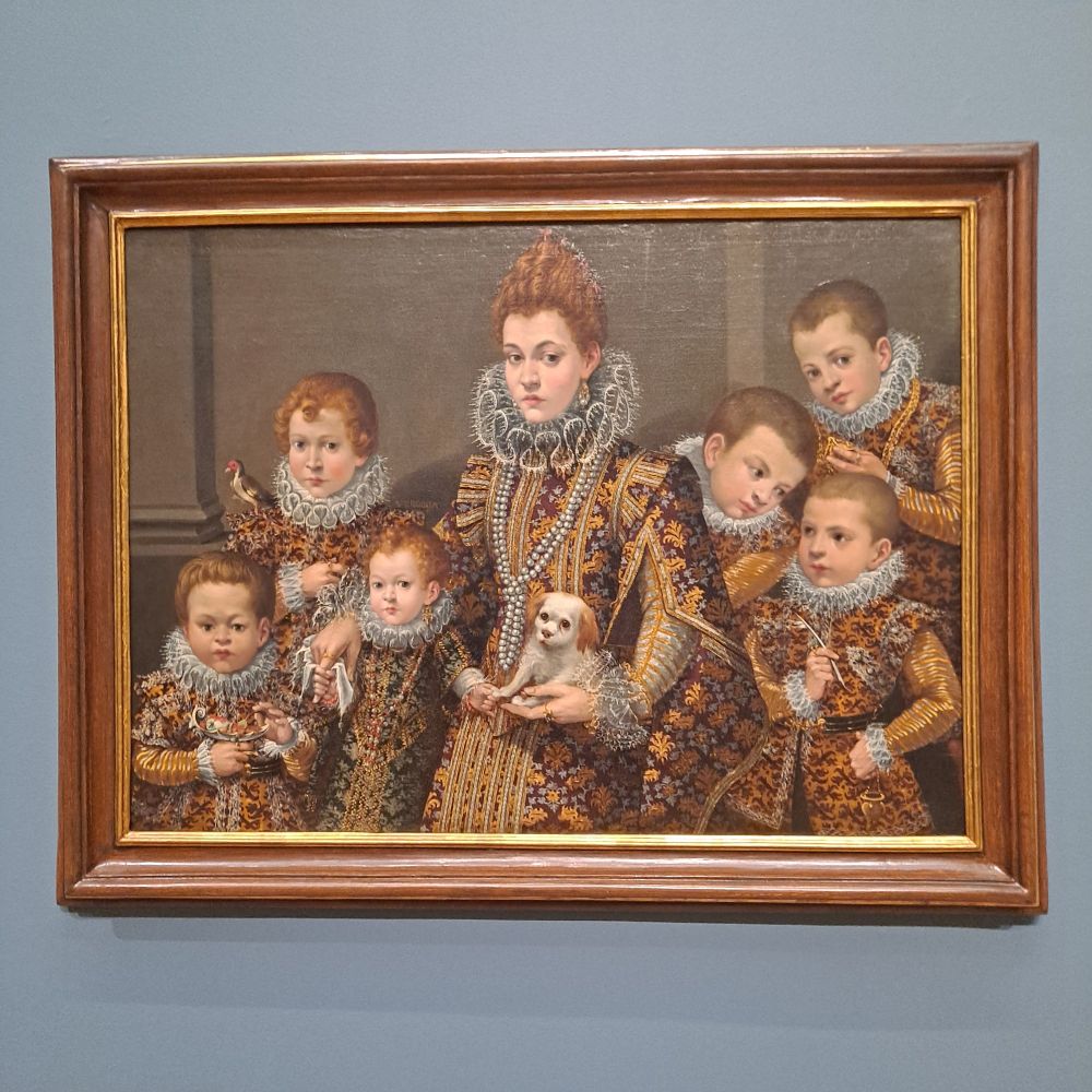Levinia Fontana, Portrait of Bianca degli Utili Maselli and Her Children. a noblewoman poses with five children and a dog. they all have ruffled collars and ostentatious, intricately patterned clothing. 