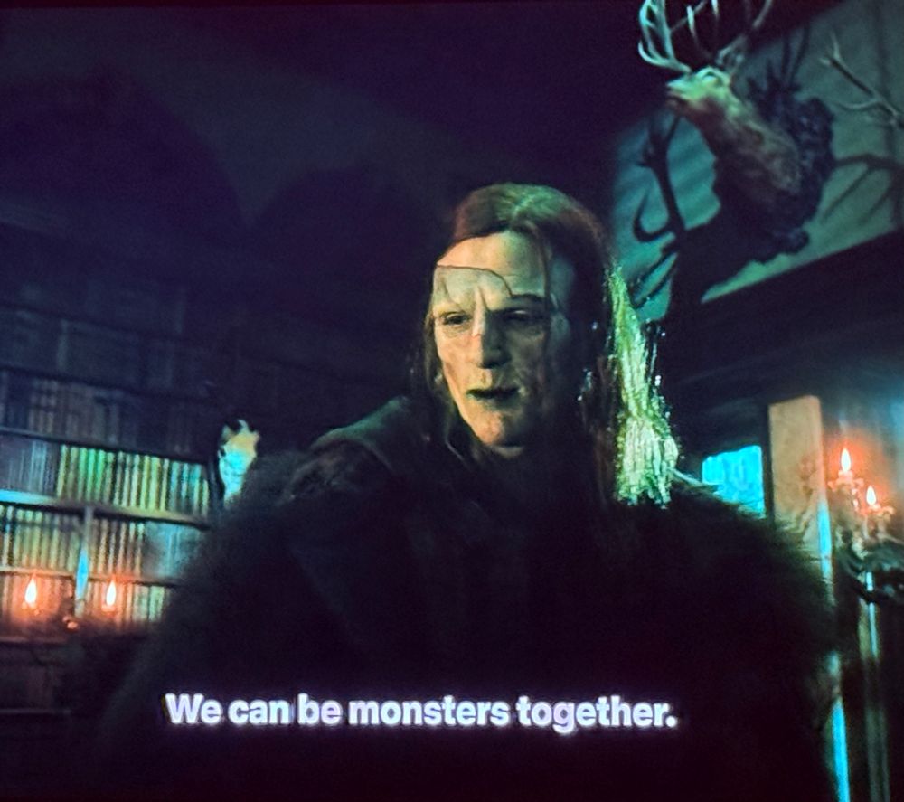 The creature from Del Toro’s Frankenstein saying “We can be monsters together.” He is in patchwork skin makeup, in a very moody study which also looks like your average goth dive bar 