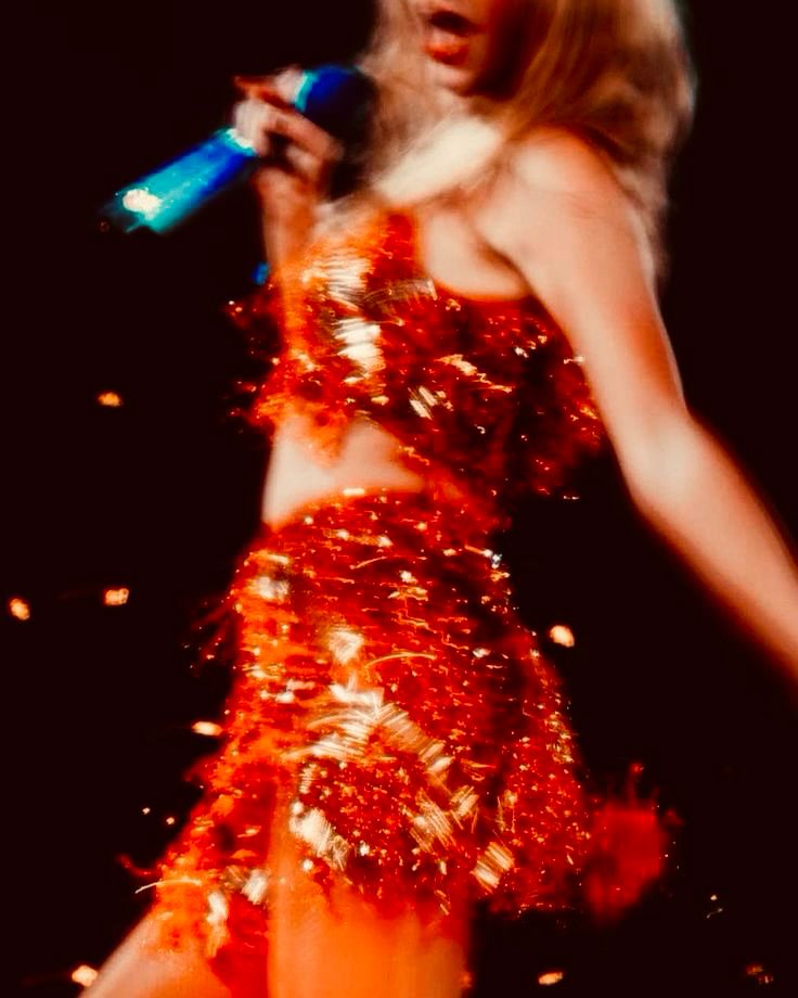taylor swift at the eras tour wearing the orange 1989 set