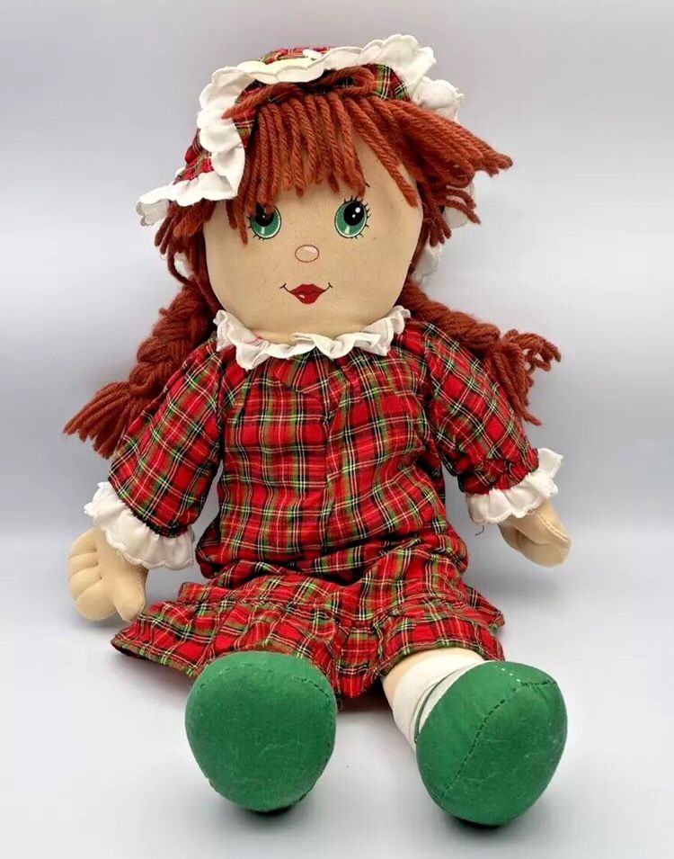 A rag doll with red-brown yarn braids wearing a red and green plaid nightgown and night cap.

She was my daughter. Her name was Becky. I got her for Christmas when I was probably 7. I was really heartbroken that she was gone, and I might never stop crying now that I have finally found another one.