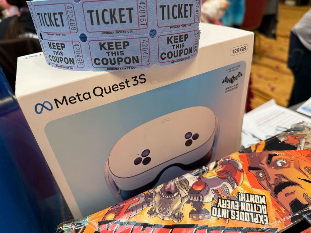 A meta quest 3S 128gb box with a roll of raffle tickets on top 
