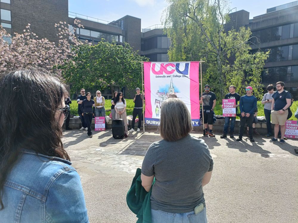 Jamie speaking to the picketers and supporters at the Durham UCU strike rally, the branch banner in the background.