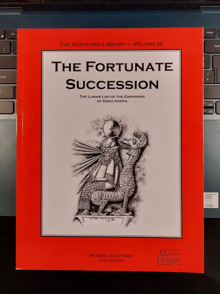The Stafford Library - Volume III. The Fortunate Succession. The Lunar List of the Emperors of Dara Happa. By Greg Stafford and Friends. The red book cover has an inset white box, with an illustration of an ancient emperor sitting on a throne made from a dragon or griffin. The symbol of the sun is poised upon his head. Rays of light shoot from his eyes, illuminating everything.