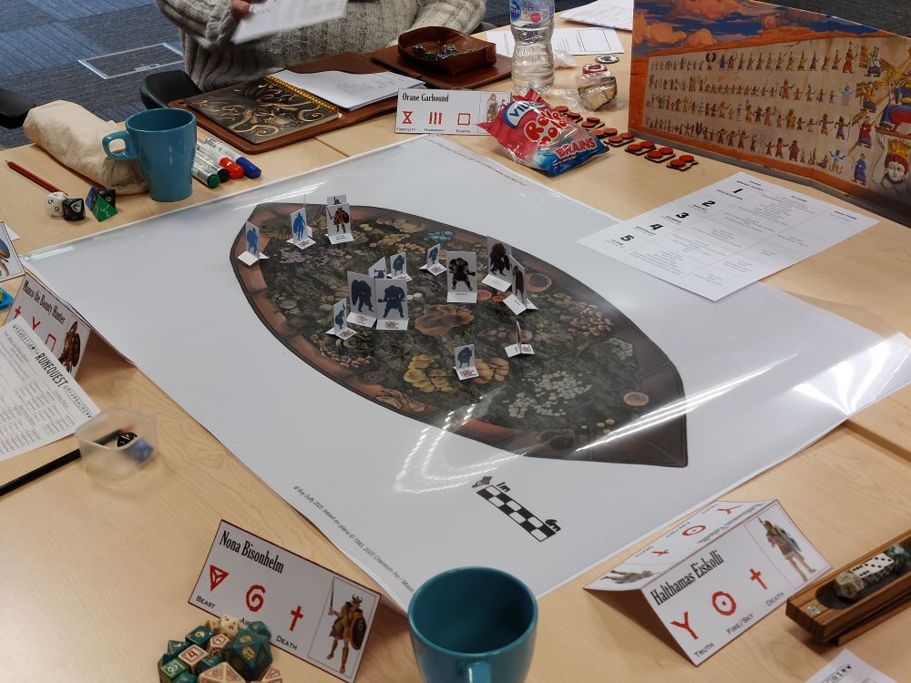 A colourful battle map on a table, it appears to show the inside of a large boat, filled with weird fungi. 