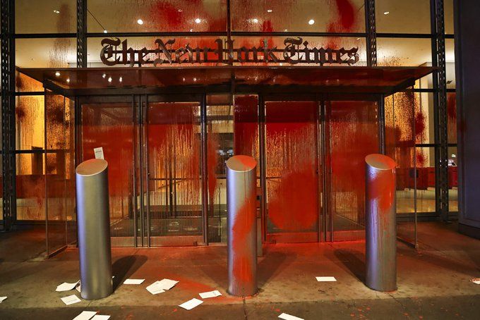 Vandalism of New York Times building; doors covered in red paint. 
