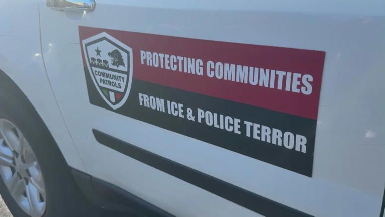 Side of vehicle with sign reading, "Protecting Communities from ICE and Police Terror"