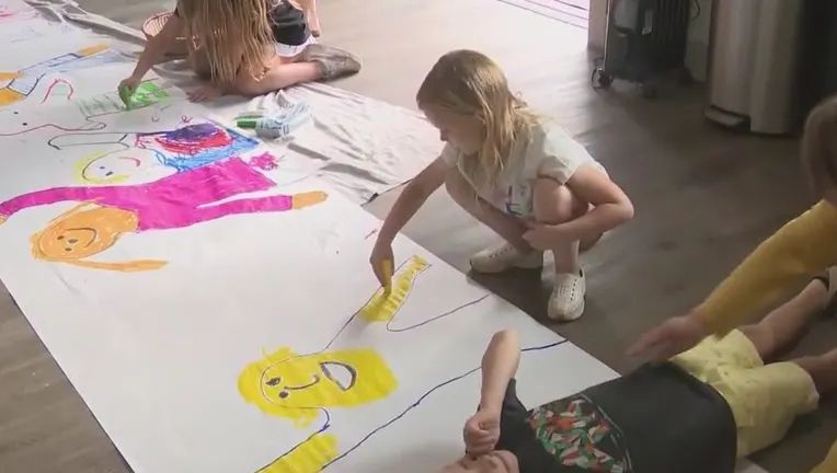 Children in Atlanta make posters in opposition to data center project.