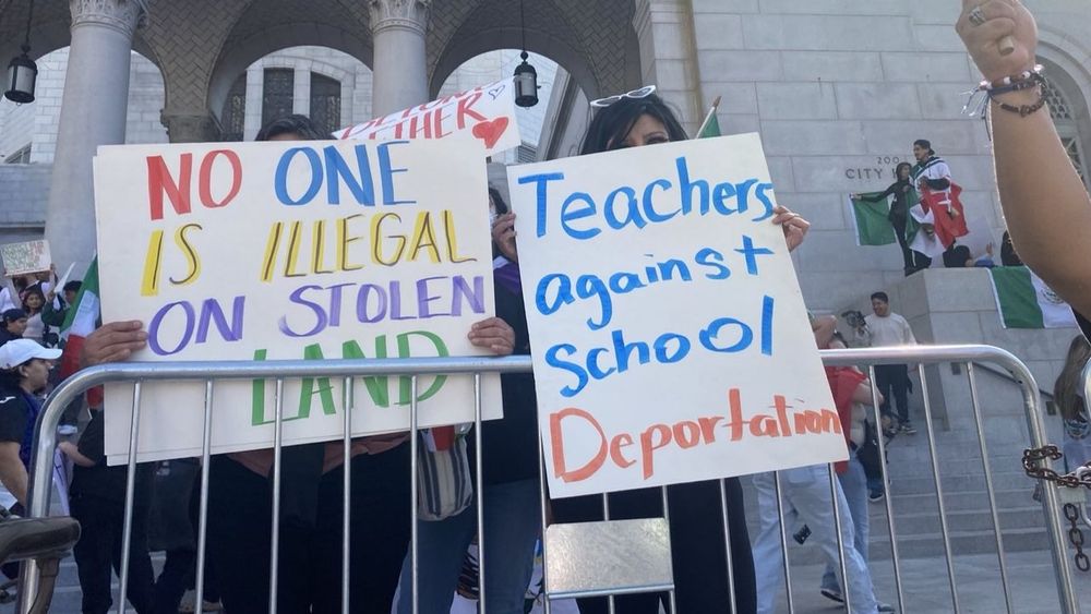 Protesters hold signs at school walkout. 