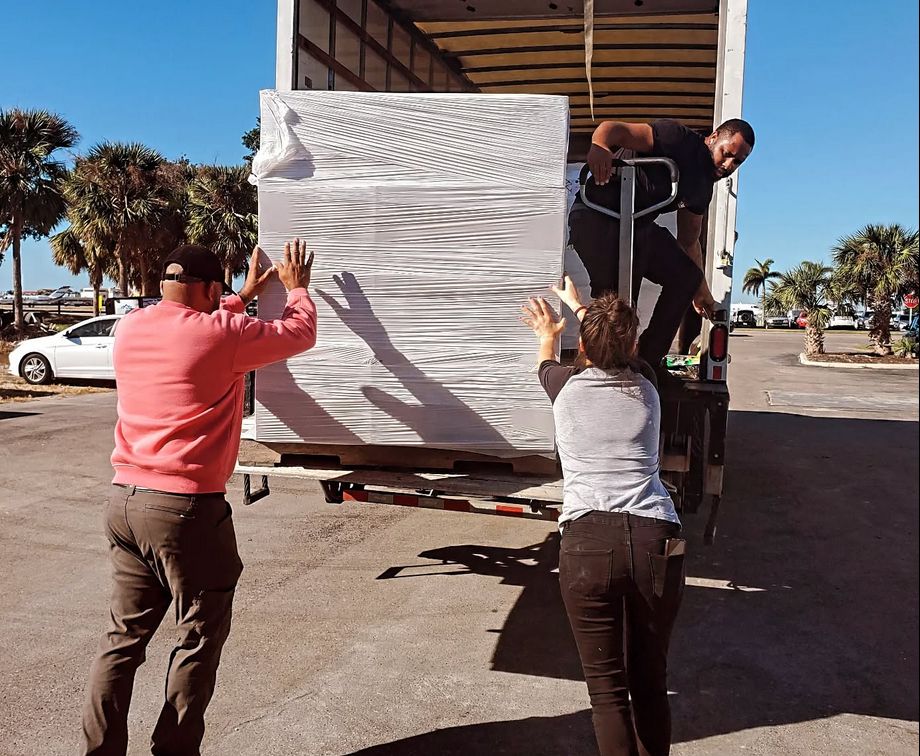 Mutual Aid Disaster Relief volunteers unload truck. 