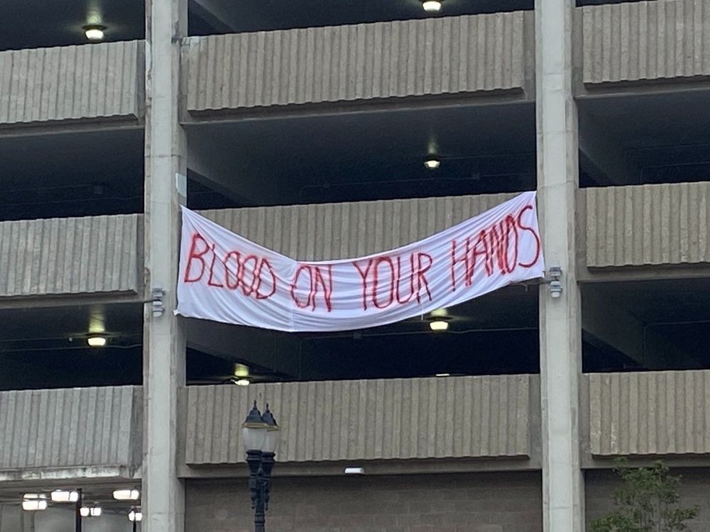 "Blood On Your Hands" banner at rally against Cop City in Michigan.