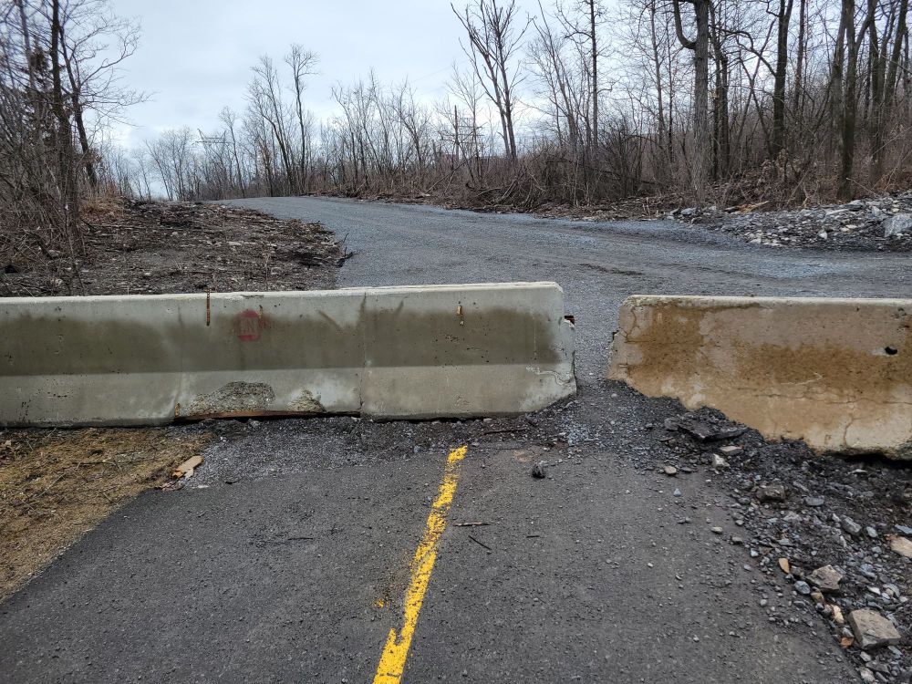 Bike lane ending in construction. Concrete barriers block the way.