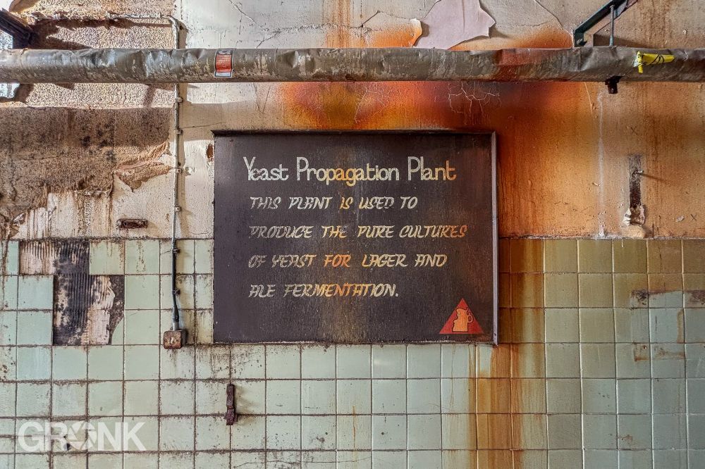 A hand painted sign with the Bass red triangle that reads: “Yeast Propagation Plant... This plant is used to produce the pure cultures of yeast for lager and ale fermentation.”