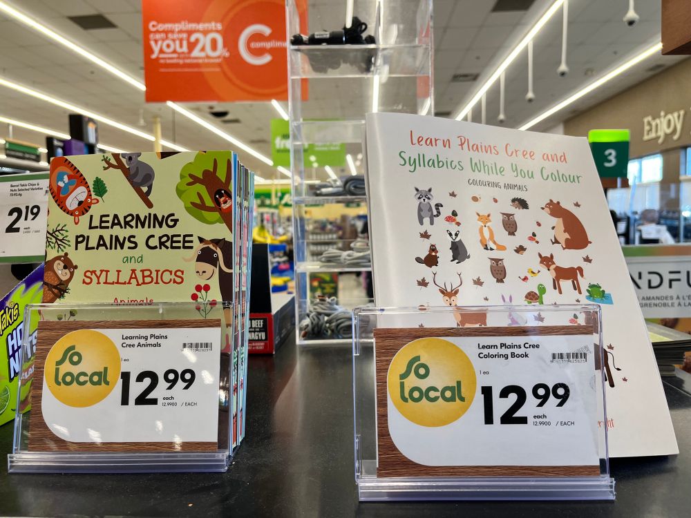 Two books with animal drawings on the cover. They are for people to learn Cree syllabics.