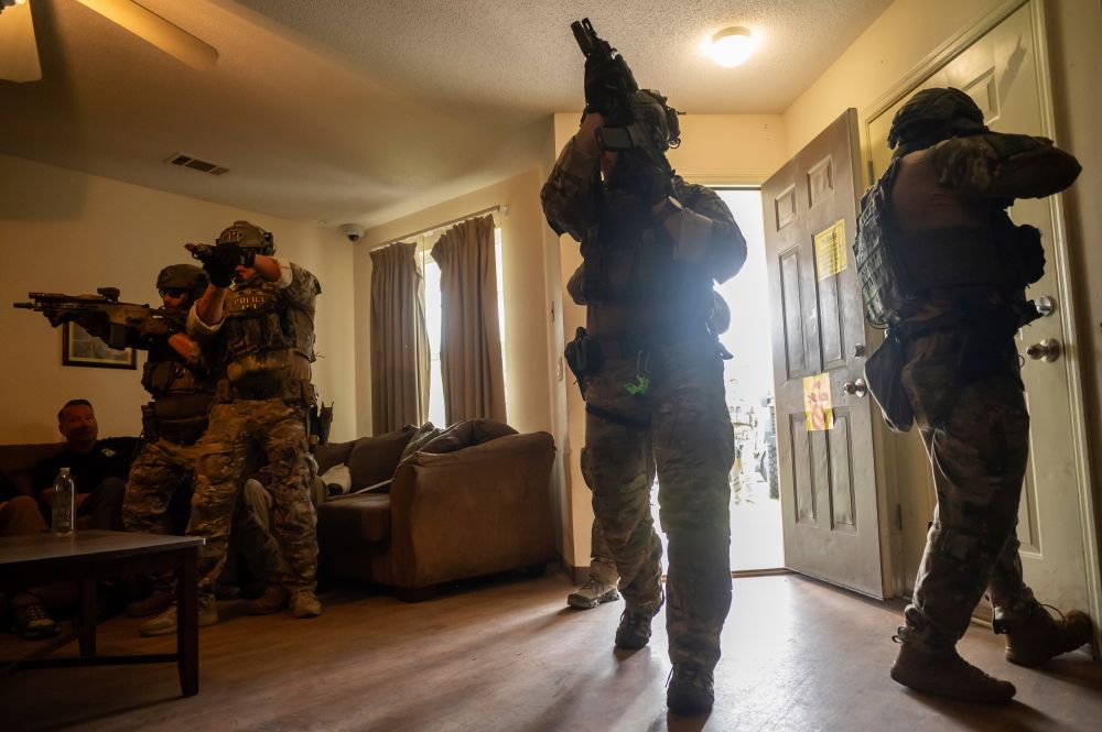 Immigration and Customs Enforcement (ICE) Special Response Team members demonstrate how the team enters a residence in the pursuit of a wanted subject at the Federal Law Enforcement Training Centers (FLETC) in Brunswick, Ga. on Thursday, Aug. 21, 2025. (AP Photo/Fran Ruchalski)