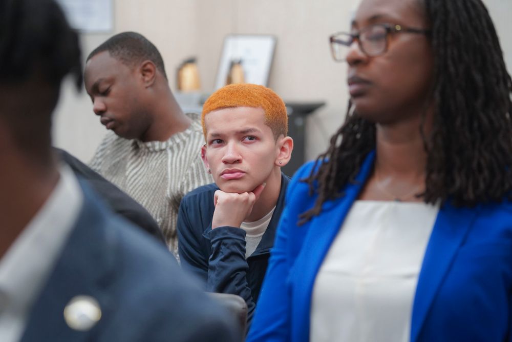 A young man with orange hair looks on at a Committee on Education oversight hearing in a hearing room at 250 Broadway. 