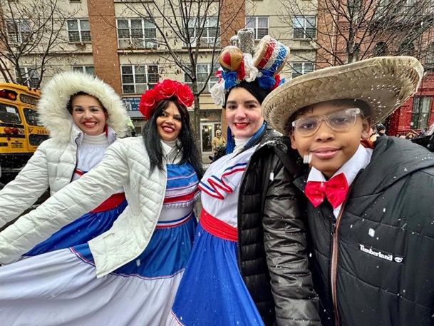 people smiling in a group photo dressed for a three kings day celebration