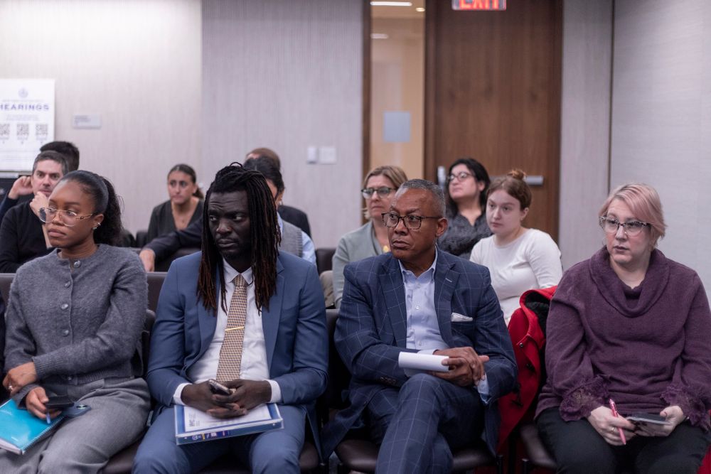 Community members look on at a Committee on Contracts oversight hearing.