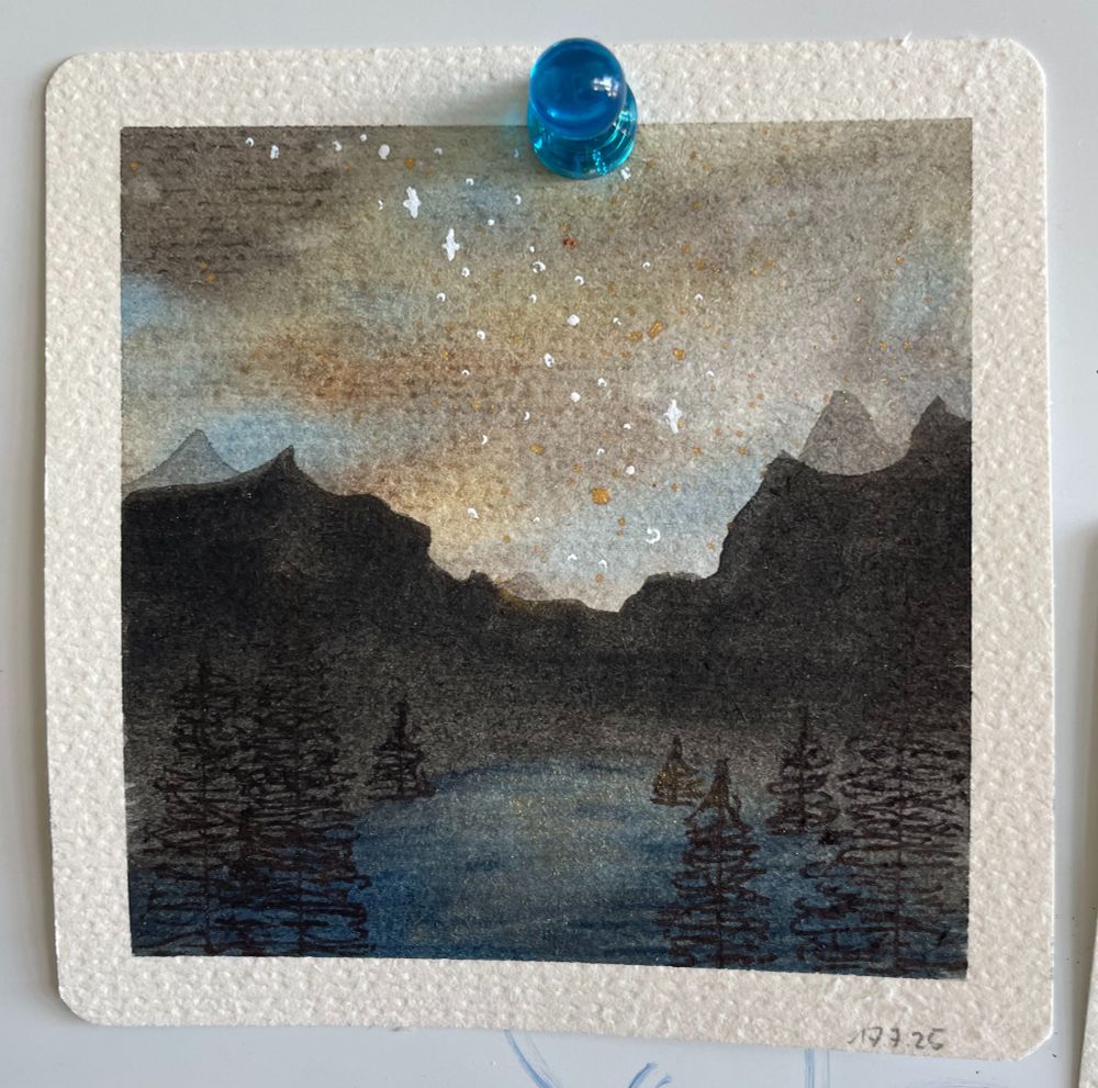 Small watercolor painting of a mountain lake and mountain range by night. Stars of a galaxy are visible and some trees.