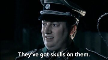 Screencap from the Mitchell and Webb "Are we the baddies?" sketch. David Mitchell as an SS officer saying, "They've got skulls on them."