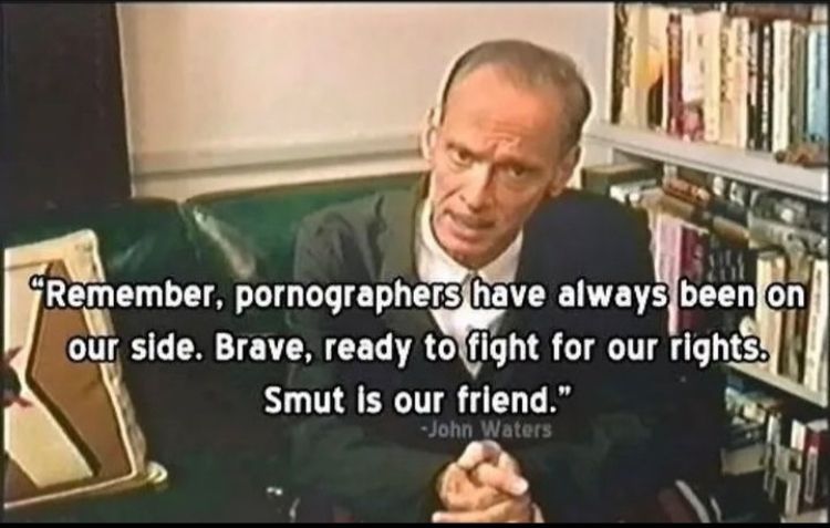 A photo of John Waters sitting down in a green leather chair. There is white text in the center of the photo. It reads "Remember, pornographers have always been on our side. Breve, ready to fight for our rights. Smut is our friend." The quote is attributed to John Waters.