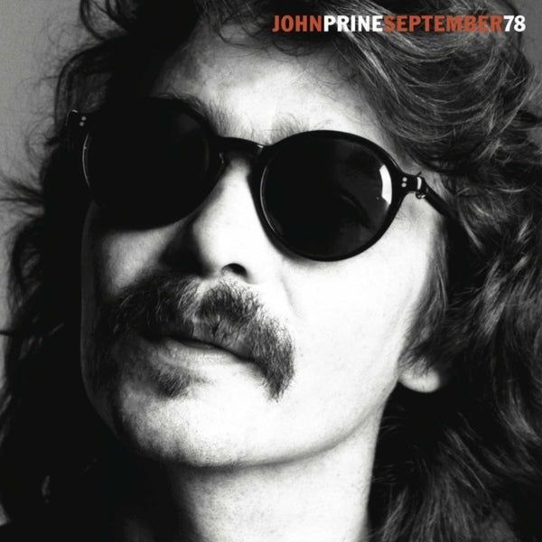 The album cover of John Prine's "September 78". It is a black and white photograph of John's face. He is wearing sunglasses and has long hair.