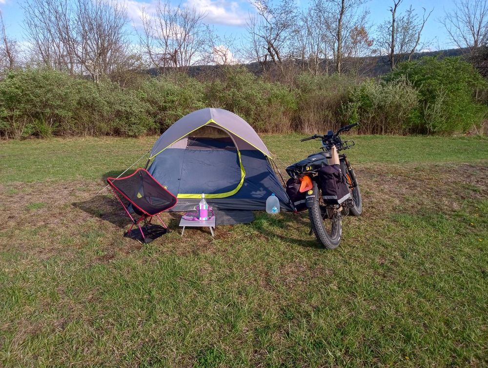 An e-bike, tent, camping chair and table