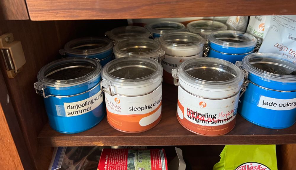 The tea has been returned to the china cabinet, completely filling the shelf.