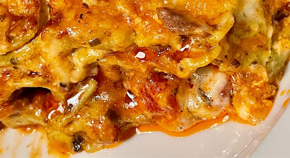 A close up of a lasagna fresh from the oven, glistening.