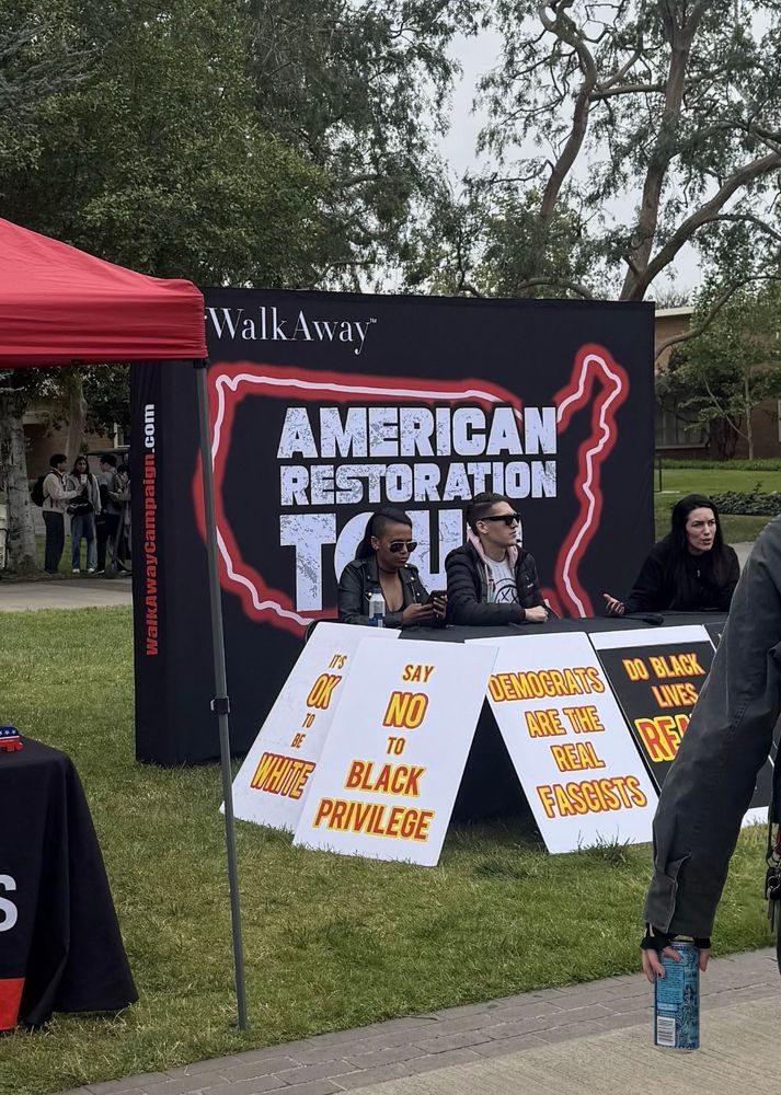 At UC Riverside, #WalkAway displays racist signs at a table on the college walkway. 