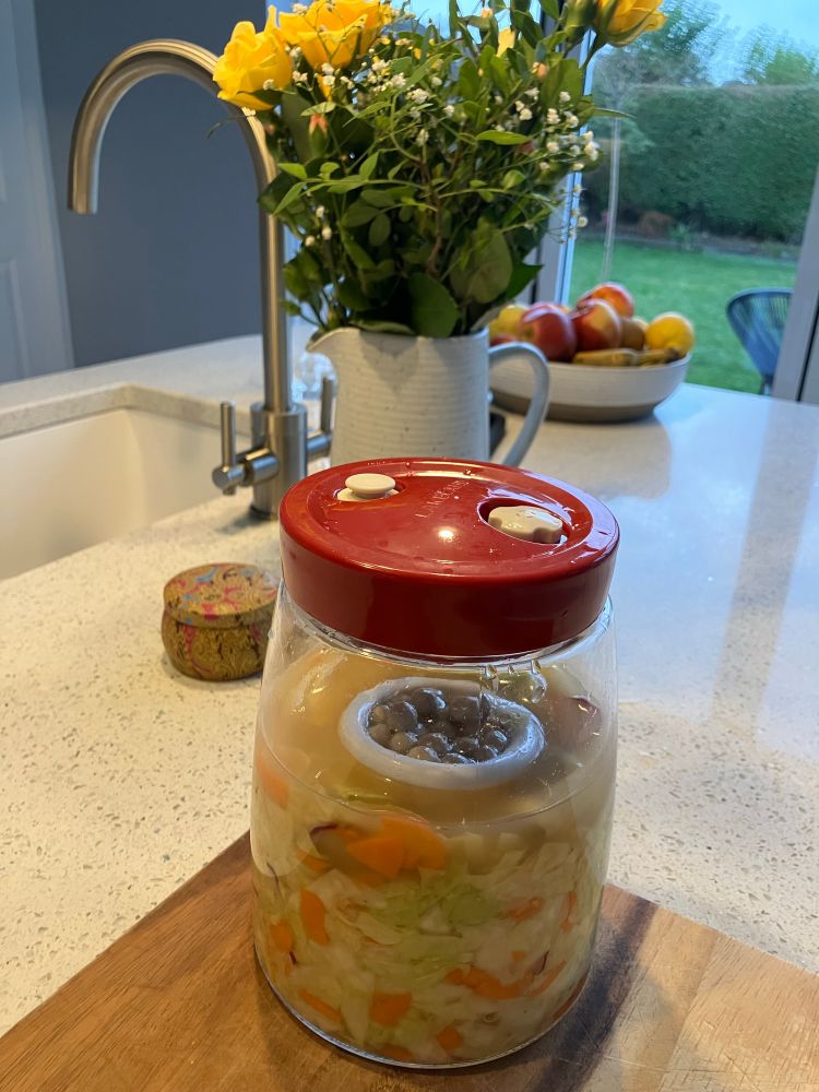 Finished Sauerkraut in jar on bench.