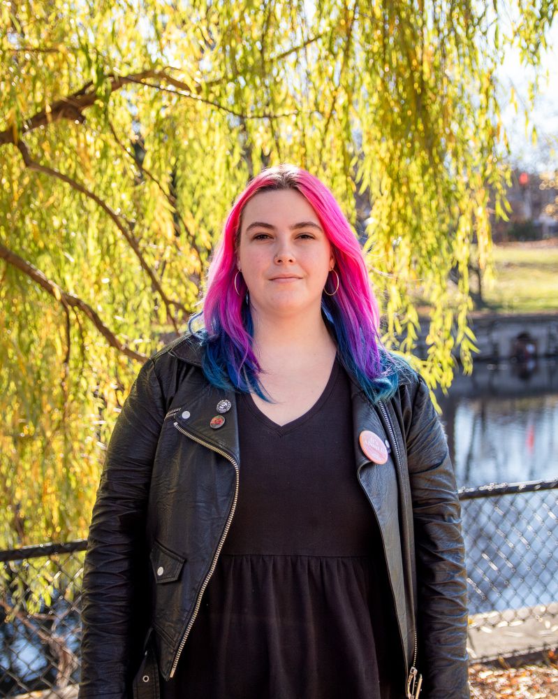 Tess stands in front of a willow tree in Patterson Creek Park