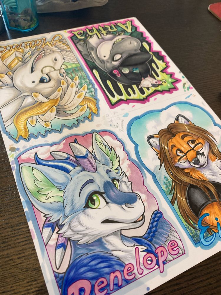 Paper filled with 4 drawings, all to be turned into conbadges 