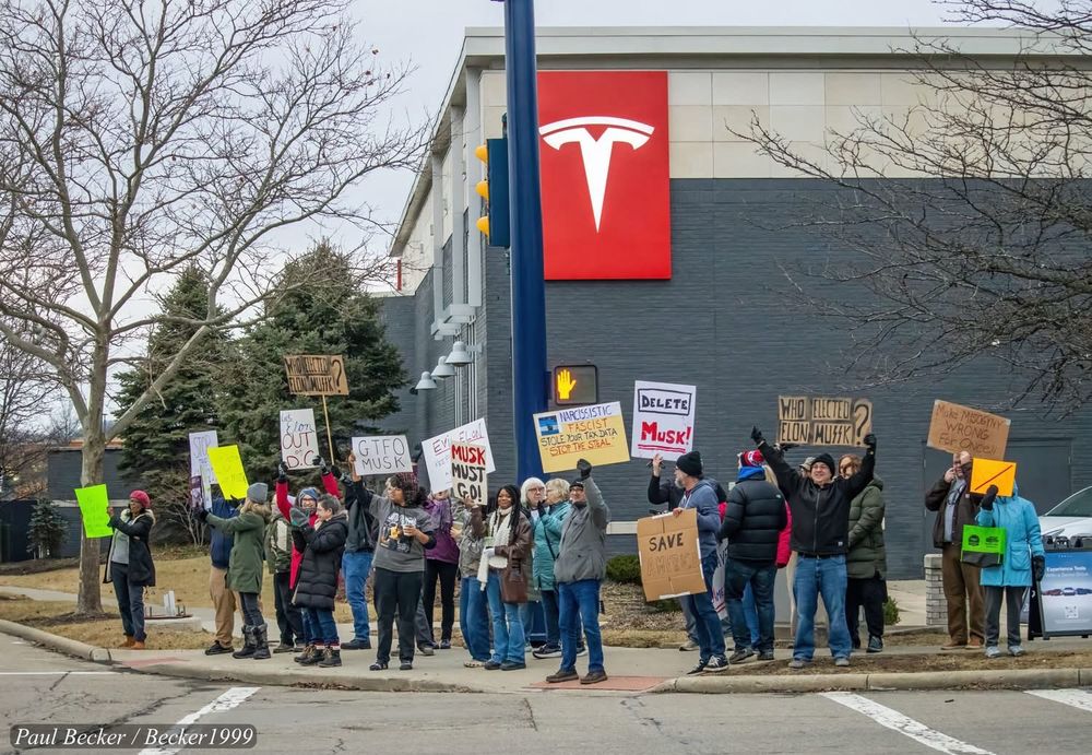 Protestors outside the Easton Tesla store in Columbus, Ohio, on the afternoon of Feb. 9, 2025. Signs read, “Musk Must Go!,” “Delete Musk!,” and “Nobody Elected MuSSk!”