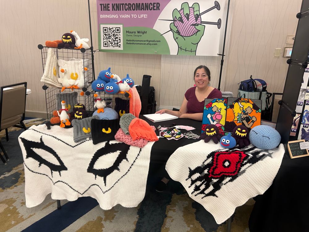 Photo of convention table for crocheted work made by me, The Knitcromancer!