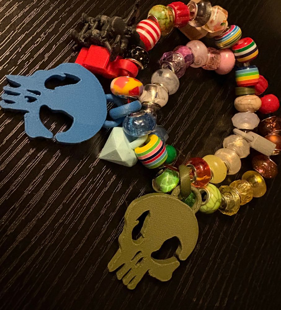 Colorful beaded bracelet with 3D printer charms serving as my badge to GrrCON.