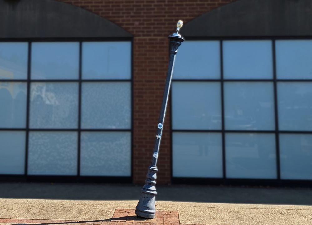 A single lamppost with a jaunty tilt to the right