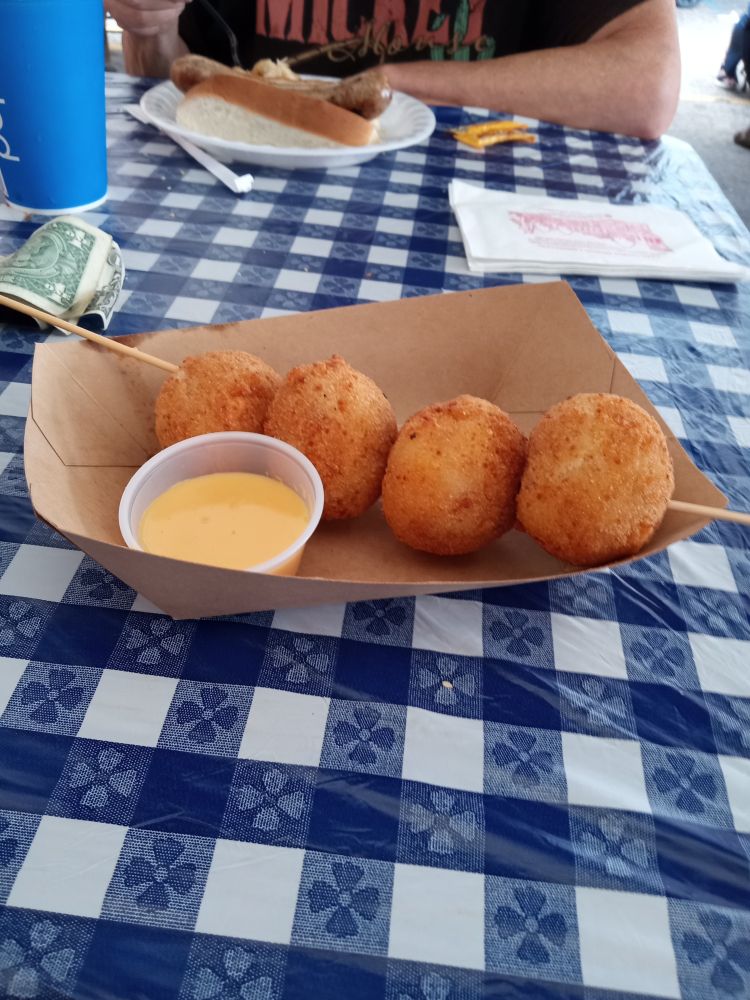 picnic table at the ohio state fair, cardboard bowl of my favorite snack there, deep fried mashed tatoes. Dad can be seen in the background with his favorite plate from Shmitt's, you can really only see his elbow