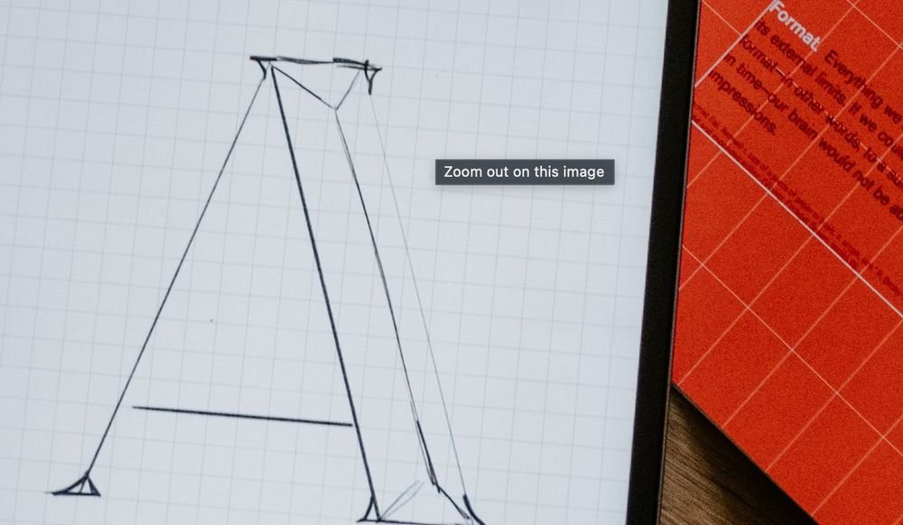 A picture of a handdrawn letter A and a bit of text from a book about Format that is very zoomed in with a visible tooltip "Zoom out on this image."